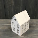 An rustic inspired metal house shaped T-light holder 