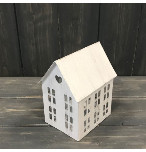A beautiful rustic inspired white t-light holder, shaped as a house with cut out window and heart details.