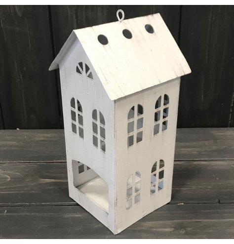 A rustic inspired t-light holder shaped as a house with cutout window detail.