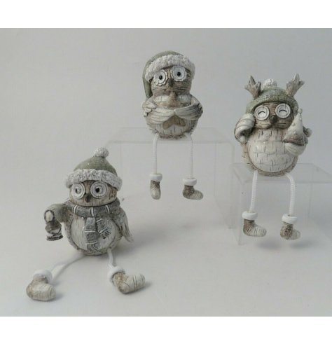 A charming little assortment of posed winter owls complete with festive accents and silver hues 