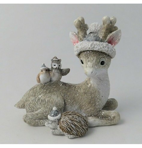 A charming little posed winter reindeer surrounded by woodland critters, featuring a sprinkle of glitter to give a frost