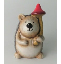 A small and sweet posed hedgehog figure with neutral colour tones and charming smile 