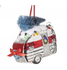 A hanging glass caravan decoration complete with festive colours and features
