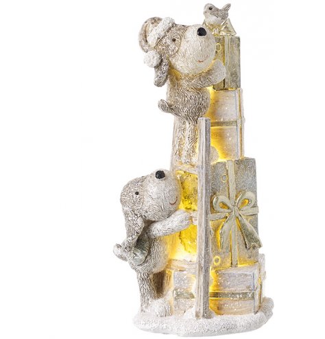 A festive little neutral toned puppy trying to reach the top of some presents! A cute decoration for the home at Christm