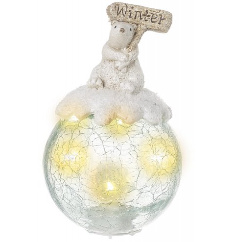 A large LED filled glass bauble set with a sweet resin bear on top with a sprinkle of glitter 
