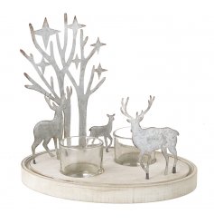 A set of clear glass candle pots featured in a wood based stand with a rustic metal Woodland and Reindeer scene 