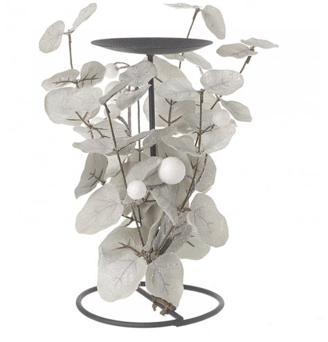 A black toned metal candle stand, wrapped with silver toned foliage leaves and berries and covered with a shimmery spark