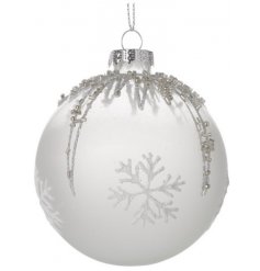 A frosted glass bauble with white snowflakes, silver glitter and beads in a pattern.