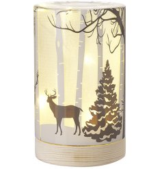 A stunning glass display set upon a natural wood base, featuring a beautiful winter woodland scene