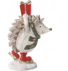 A fun and festive skating hedgehog decoration in traditional red, green and gold colours.