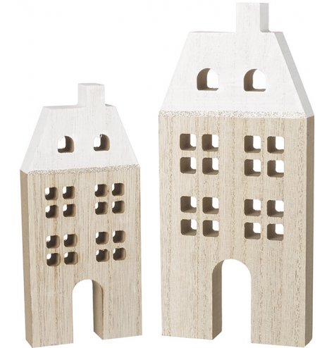 An assorted sized set of minimalistic inspired wooden houses, both decorated with a snowy white roof and glitter trim 