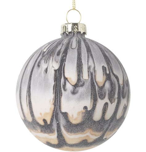 An elegant glass bauble decorated with a grey and taupe drip pattern 