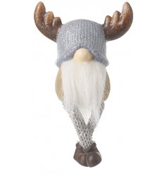 A shelf sitting gonk figure with glittery antlers and dangly knitted legs 