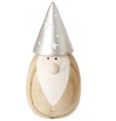 A small wooden gonk with painted features and a silver pointed hat with stars 