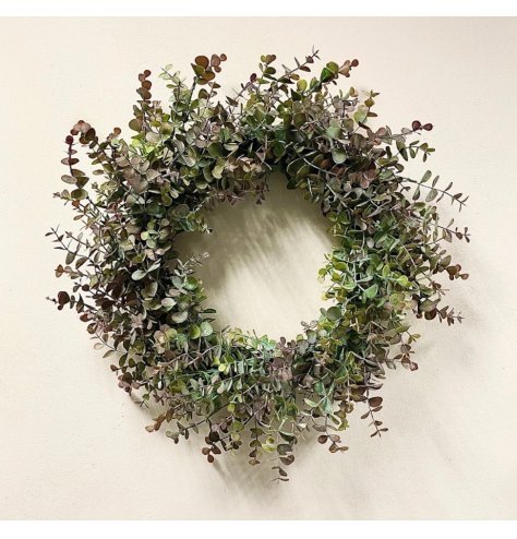 An on trend Christmas wreath with a flurry of eucalyptus foliage in green and purple hues 