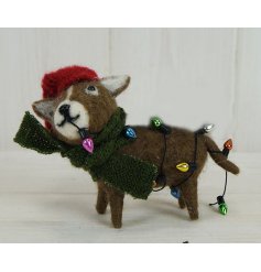 A fuzzy woollen dog decoration with festive accents and colourful lights  