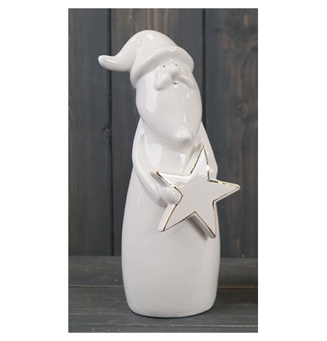 A small ceramic santa with a sleek white glaze and gold detailing 