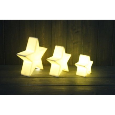 A small ceramic star with all white tones complete with a warm glowing LED central light 