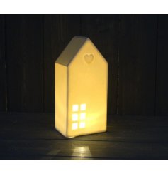  A simple white toned house with a warm glowing LED centre, embossed star decal and added grey hue 