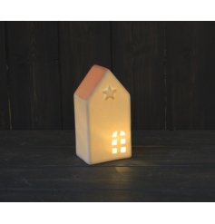 A simple white toned house with a warm glowing LED centre, embossed star decal and added pink hue 