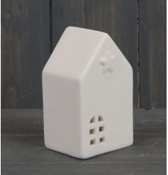 A simple white toned house with a warm glowing LED centre and embossed star decal 