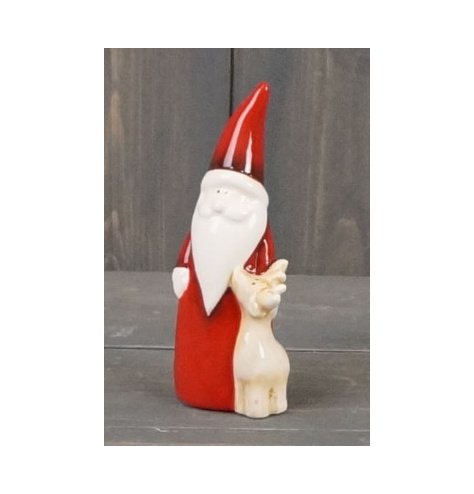 A small ceramic Santa and Reindeer figure complete with a smooth glazing and traditional colour tone 