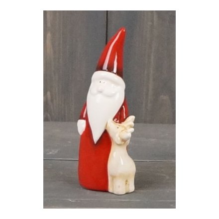 A charming and simple ornamental Santa figure with a little reindeer feature and sleek red toned look 
