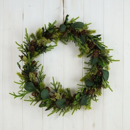 A large rounded wreath made of woodland floor inspired foliage 