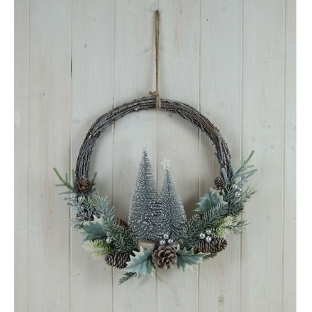 A half done wreath with a woven rattan base and charming festive themed foliage on the bottom