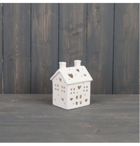 A charming ceramic house t-light holder, finished with cut out windows, doors and small hearts to allow the candle light