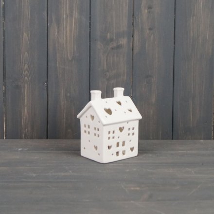 A charming ceramic house t-light holder, finished with cut out windows, doors and small hearts to allow the candle light