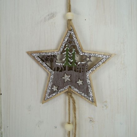 A natural wooden hanging star with a rustic woodland scene inside and a glittery touch to finish 