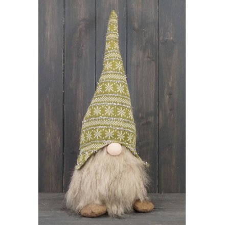 A brown and green toned fabric gonk figure with long dangly legs and faux fur trims 