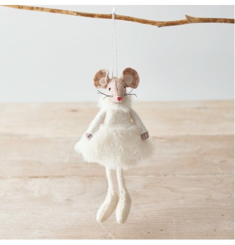 A adorable hanging fabric mouse with beige tones and a fluffy white dress to complete her look 