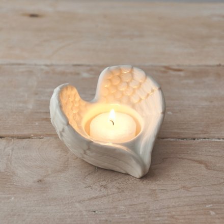 A simple angel wing shaped tlight holder beautifully set with a simple white glaze finish 