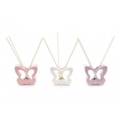 An assortment of pink, white and purple toned ceramic butterfly diffusers complete with scented sticks for each 