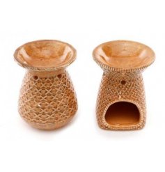 An assortment of woven rattan inspired oil burners in a rust orange tone 