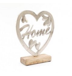 A sleek and simple metal heart ornament set upon a natural wood block, beautifully finished with a distressed finish 