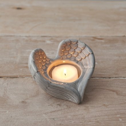 A simple angel wing shaped tlight holder beautifully set with a simple grey glaze finish 
