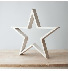 A large standing natural wood Star with a rustic white washed colour to it 