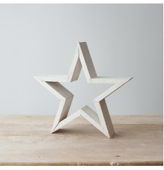 A chic and simple standing wooden framed star set with a rustic white washed coating