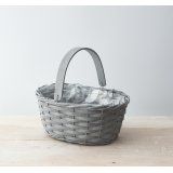 A charmingly simple woven wooden trug in a grey tone, complete with a matching handle and plastic inner lining 