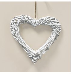 A woven wicker wreath in a heart shape, complete with a white washed finish and jute string for hanging