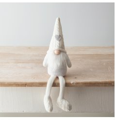 A sleek and chic sitting fabric gonk figure with all white details and a glittered heart hat 