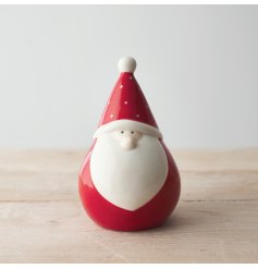 A small and plump little sitting Santa gonk with a polka dot hat and simple complexion 
