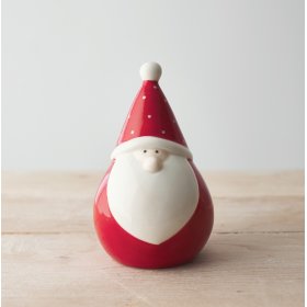 A small and plump little sitting Santa gonk with a polka dot hat and simple complexion 