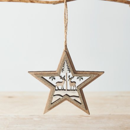 A charming simple rustic wooden star hanging decoration with a glitter trim and woodland scene cut out 
