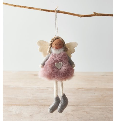 A cute and plush hanging angel decoration with a pink toned faux fur body and added white accents