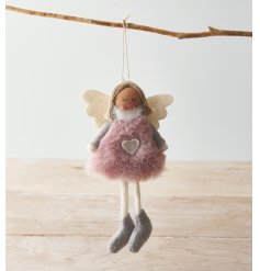  A festive themed faux fur bodied angel with pink and white tones 