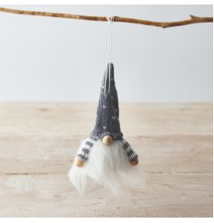 A traditional themed fabric plush hanging gonk with a grey toned knitted hat and faux fur features